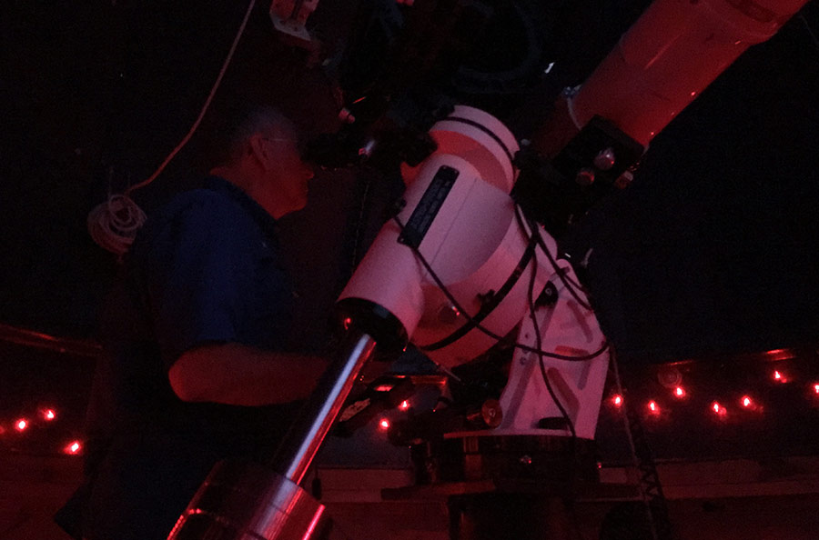 Randy Light looks through his telescope in the Regina Caelorum Observatory