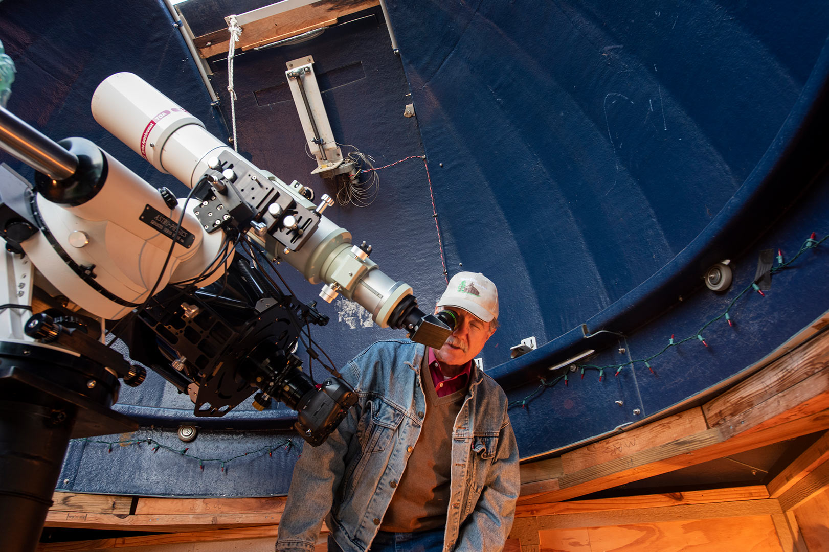 Dr. Spearman looking through telescope