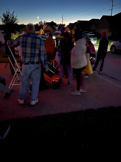 Trick-or-Treaters looking through telescope