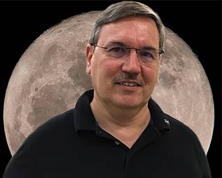 Tom Campbell with moon behind him